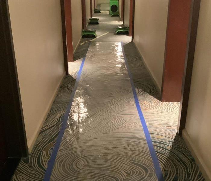 Drying equipment set up in hallway of a hotel.