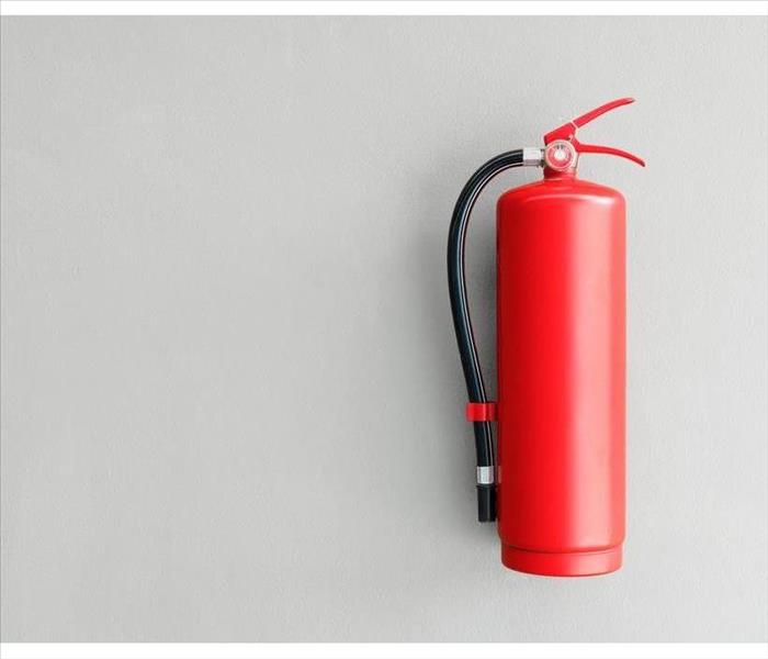 Fire extinguisher on the gray wall