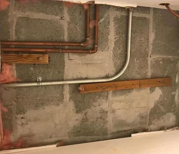 Drywall removal, pipes against a wall